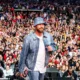 Travis Kelce is showing his love for Taylor Swift at Kelce Jam: The 34-year-old tight end for the Kansas City Chiefs hosted the second year of his music festival this weekend on Saturday, May 18, in Kansas City, featuring performances by Lil Wayne, Diplo, and 2 Chainz