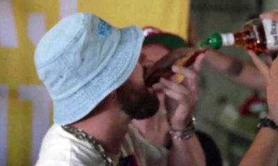 Travis Kelce downs a whiskey shot from a slice of BREAD and sings on stage with Patrick Mahomes as he lets loose at his music festival after leaving girlfriend Taylor Swift in Europe