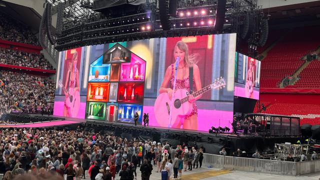 Taylor Swift thanks poncho-wearing Swifties after they waited hours in the rain at Anfield for her 100th Eras Tour show - and confirms end date for 'exhausting' record-breaking run of gigs