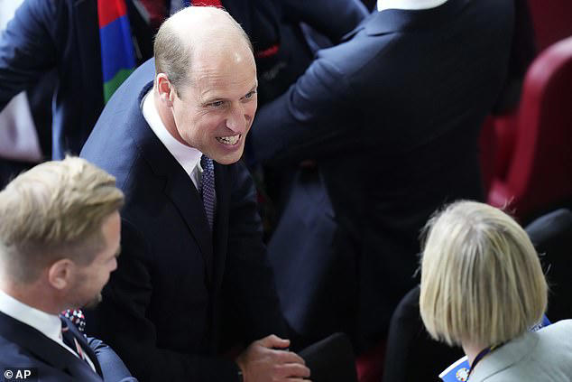 Prince William arrives to cheer on Gareth Southgate's Three Lions as England take on Switzerland in Dusseldorf: Cutting a fine figure in a navy suit and blue tie, the Prince of Wales joined guests in the stands as the England National Team sang 'God Save the Kick' before kick-off.