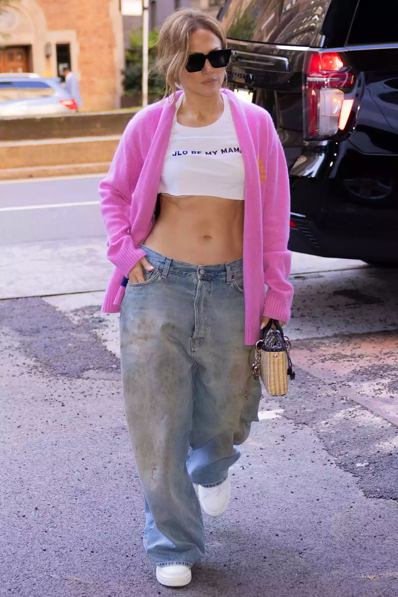 Jennifer Lopez Flaunts Her Abs in White Crop Top and Baggy Jeans During Solo N.Y.C. Outing: Lopez was spotted wearing her wedding ring with the casual attire